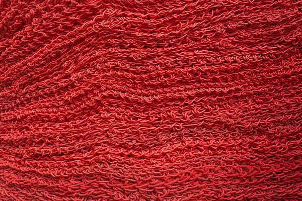 Close up design decorativo tricotado fundo vermelho — Fotografia de Stock