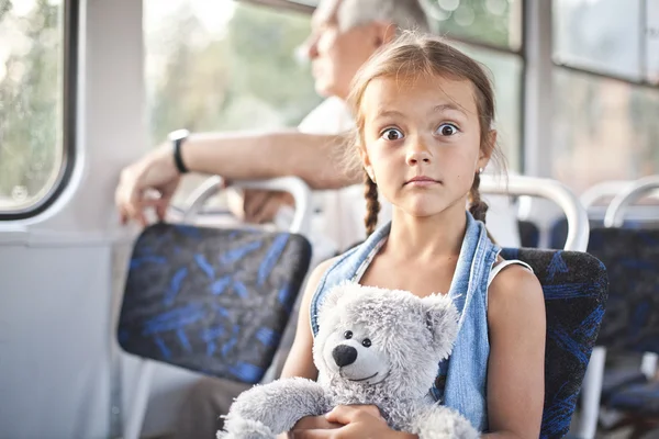 Funny open eyed girl in a tram — Stock Photo, Image