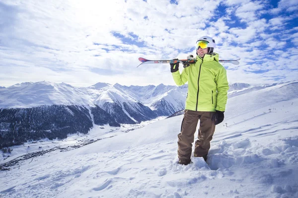 Uomini sportivi con gli sci in una località di montagna innevata — Foto Stock