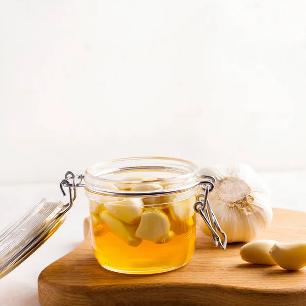 흰 접시에 마늘을 얹어 발효시킨 꿀이다. 복사 공간 — 스톡 사진
