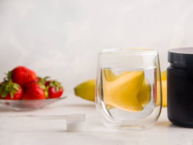 The concept of drinks useful for people involved in sports. Fortified drink next to fruit