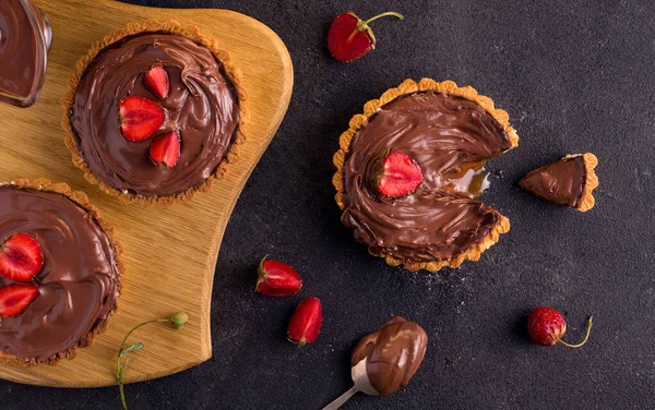 Homemade tart on a dark background. View from above