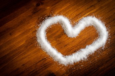 Doğal beyaz organik deniz tuzu tozunu kapayın öğütücü şişesinde pişirin cam parçaları antika siyah mutfak ahşap masa sağlıksız kalp krizi sorunu