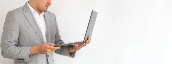 Professional Business man in suite hand hold computor coffee in paper on isolated white background