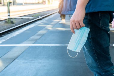 Boş platform tren durağı metrosu metro istasyonu yolcuları turistler ayakta bekliyor yeni normal sosyal mesafeli hijyen maskeli güvenli yolculuk covid corona virüsünden korunmak için
