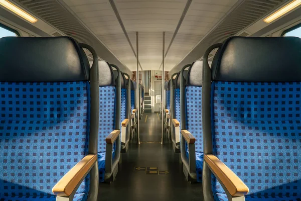 Clean hygiene empty blur motion seat on europe Germany public transportation train subway bus with sunlight for traveler to travel during vacation with nature view on window