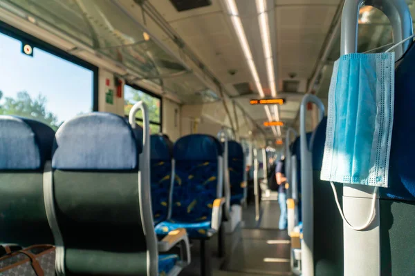 Empty inside train bus subway public transport with window view and blue seats people tourist new normal social distancing safe travel with hygiene face mask protect from covid corona virus