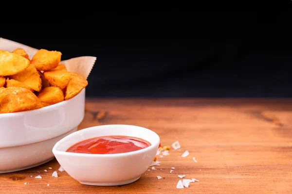 Tradition french fries from organic bio potato wedges with skin dip in ketchup