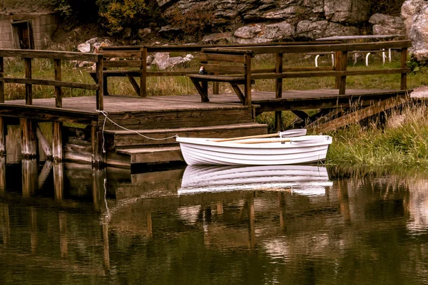 Small row boat sitting in pond Royalty Free Stock Images