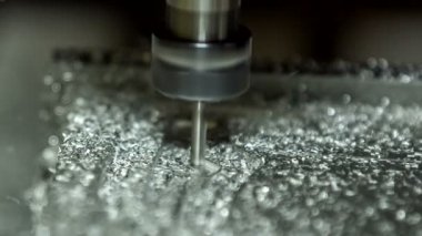 Metal lathe is slowly cutting aluminium