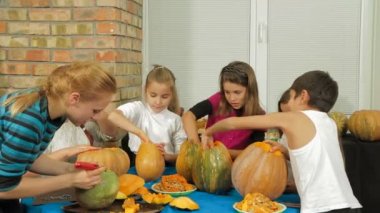 Adults and children carving pumpkins
