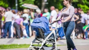Mother walking with baby in the stroller
