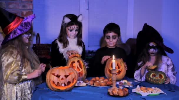 Children in a costumes lighting candles — Stockvideo