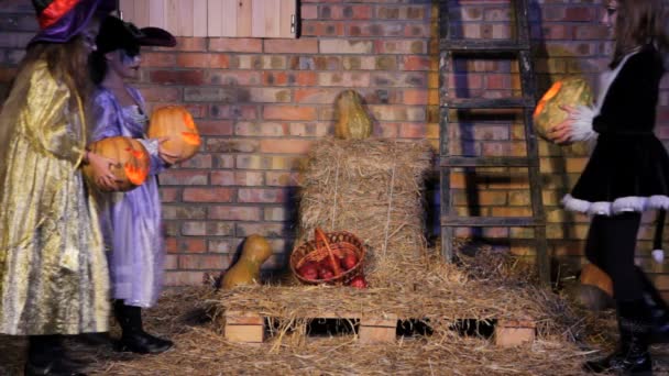 Children in Halloween costumes with pumpkins — Stock Video