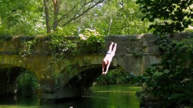 Man Jumping Into The River. Slow-Motion