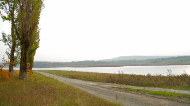 Road And Footpath In Autumn Landscape Near Lake — Stock Video