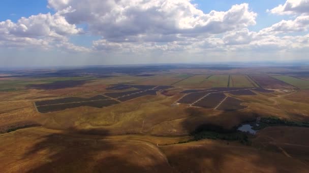 Aerial View Of Solar Power Stations Amidst Agricultural Fields — Stock Video