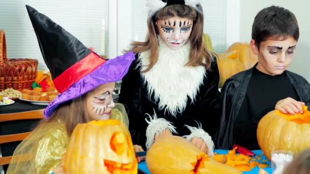 Children In Halloween Costumes Cutting Pumpkins — Stock Video