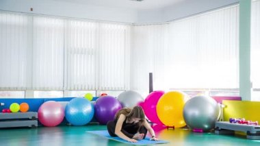 Woman Practicing Seated Forward Bend Yoga Exercise