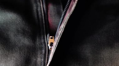 Kotun 4K metal fermuarı yakın plan. Mavi kot kumaş. Makro çekim