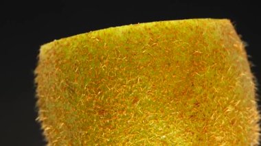 4K Cut Kiwi fruit isolated on black background, Three kiwi fruit, Close up. Rotating shot.