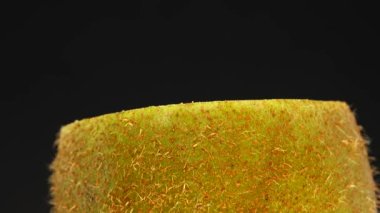 4K Cut Kiwi fruit isolated on black background, Three kiwi fruit, Close up. Rotating shot.