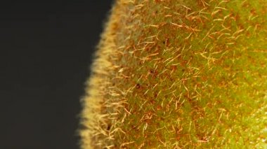 4K Cut Kiwi fruit isolated on black background, Three kiwi fruit, Close up. Rotating shot.
