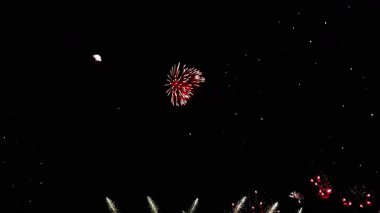 4 bin. Gerçek havai fişeklerin kusursuz döngü arka planında gece gökyüzünde Bokeh ışıkları olan altın havai fişekler. Parlak havai fişek gösterisi. Yeni yıl arifesinde havai fişekler birden fazla rengi kutluyor.