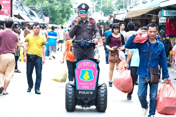 BANGKOK THAILAND -OCTOBER 18 Chatuchak Weekend Market Police tourists check out the safety of tourists.The product went on the market with its gas scooter Instead of patrolling by foot OVTOBER 18,2015