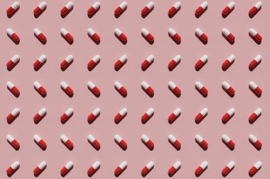 Pembe arka planda kırmızı ve beyaz kapsüller. 3B görüntüleme