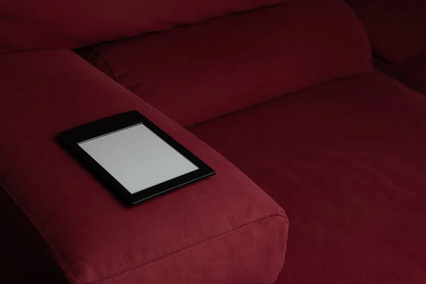 Modern e-book on a red sofa