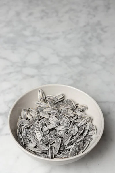 Pile of salted and roasted sunflower seeds in a bowl