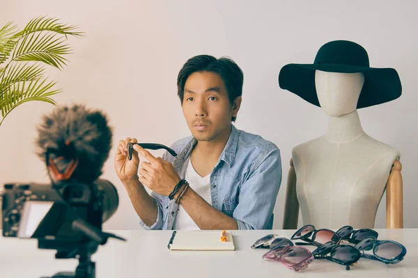 Video Kayıt 'tan Asyalı Vlogger ya da Manken İncelemesi Siyah Moda Gözlüğü Ürünleri Blog yazarı. Serbest Çalışan Çevrimiçi Müşteri ile Canlı Yayın Vintage Tondaki Sosyal Medya