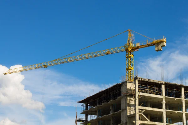 Tower Crane Wide Screen and Skyscraper on Blue Sky Background Stock Image