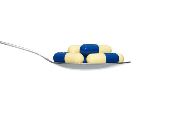 Blue Beige Medicine or Capsule on Spoon Isolated on White Backgr — Stock Photo, Image