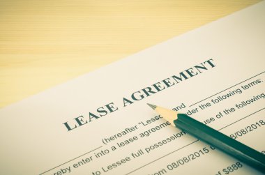 Lease Agreement Contract Document and Pencil at Bottom Right Corner Vintage Style