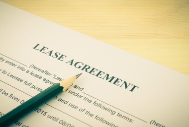 Lease Agreement Contract Document and Pencil Bottom Left Corner Vintage Style