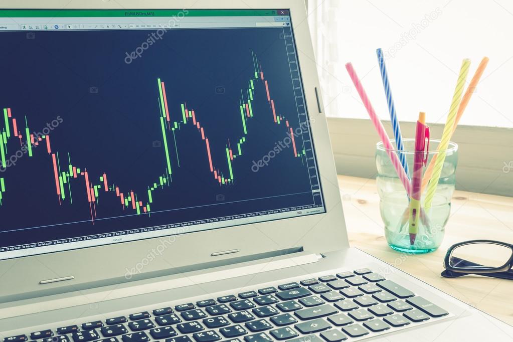 Stock or Forex Graph in Laptop Screen on Left View on Blue Vintage Style