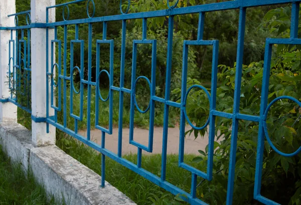 Dekoratív Kék Fém Kerítés Beton Alapon Háttér Zöld Fák — Stock Fotó