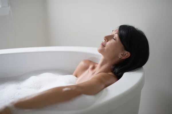 Mature woman in a bathtub — Stock Photo, Image