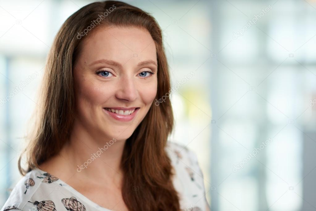 Horizontal headshot of an attractive caucasian business woman shot with shallow depth field.