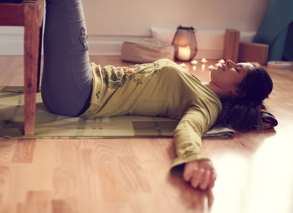 Attractive mixed race woman doing restorative yoga — Stock Photo, Image