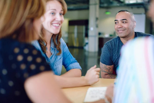 Unposed group of creative business people in an open concept office brainstorming their next project. — Stock Photo, Image