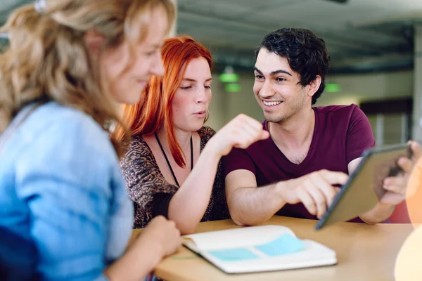 Unposed group of creative business people in an open concept office brainstorming their next project. — Stock Photo, Image