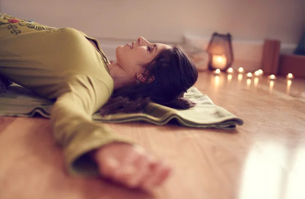 Attractive mixed race woman doing restorative yoga — Stock Photo, Image