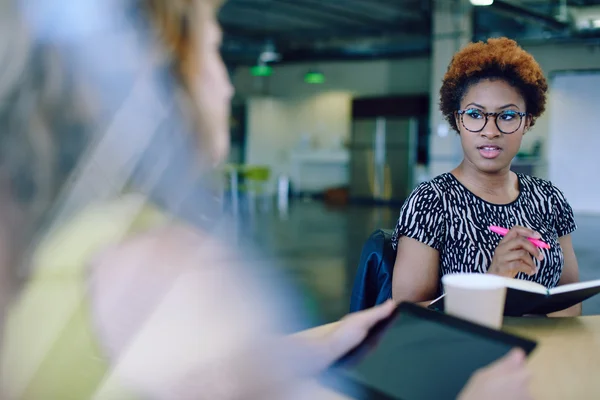 Unposed group of creative business people in an open concept office brainstorming their next project. — Stock Photo, Image