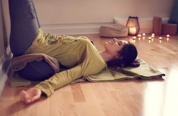 Attractive mixed race woman doing restorative yoga — Stock Photo, Image