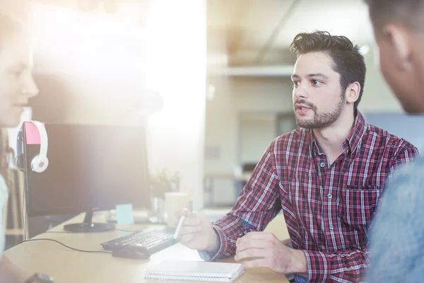 Unposed group of creative business people in an open concept office brainstorming their next project. — Stock Photo, Image