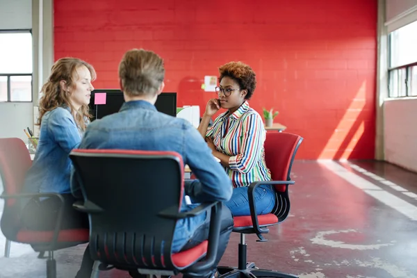 Unposed group of creative business people in an open concept office brainstorming their next project. — Stock Photo, Image