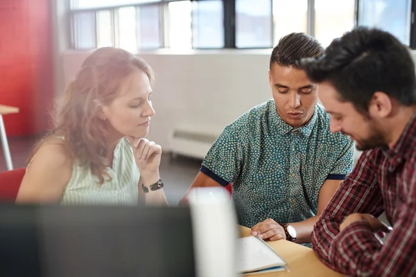 Unposed group of creative business people in an open concept office brainstorming their next project. — Stock Photo, Image